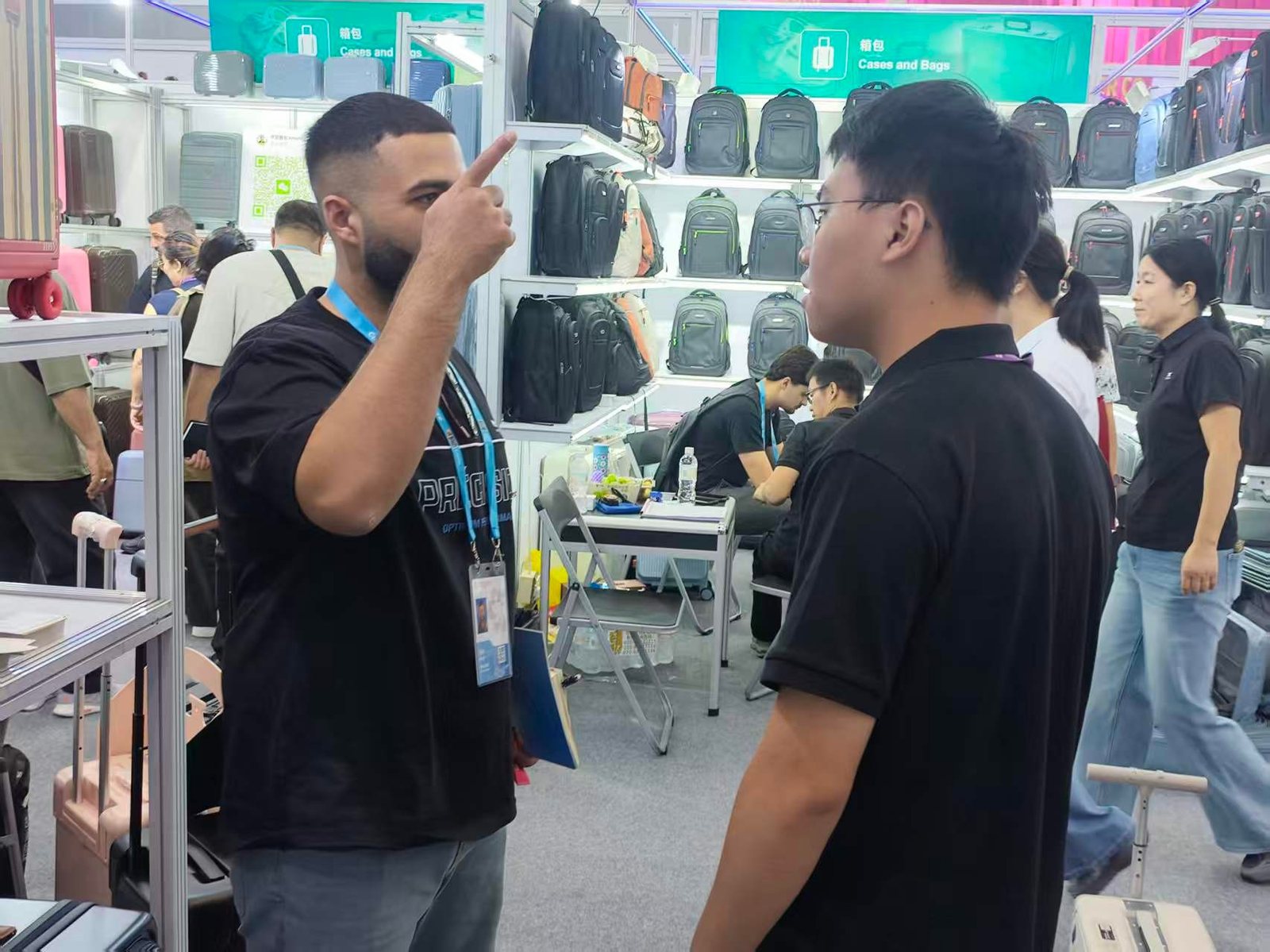 A buyer in conversation with a CLK staff member at the booth, pointing at the sample on the shelf