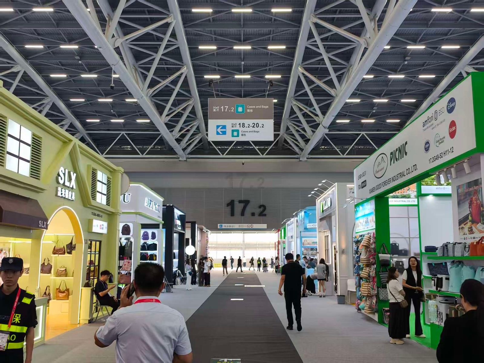 The walkway into Hall 17.2 with luggage stands on both sides