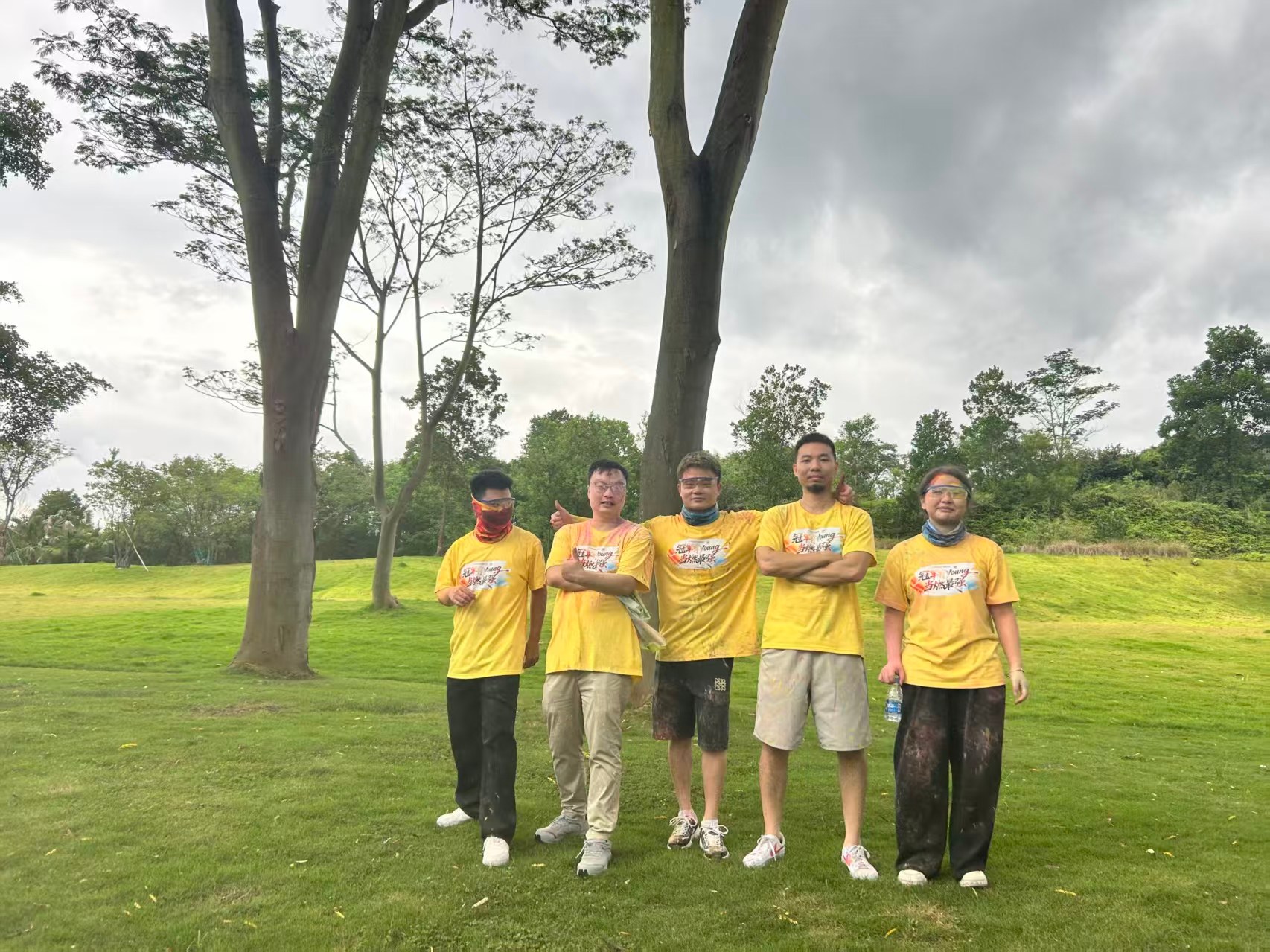 CLK Luggage team building 2026 - team in yellow shirts covered in color powder